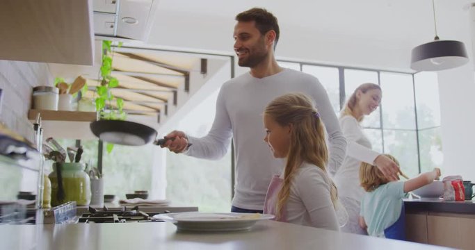 Family preparing food in kitchen at home 4k