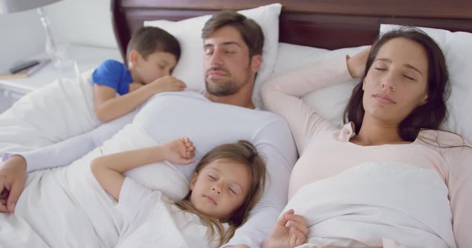 Family Sleeping Together On Bed In Bedroom At Home 4k