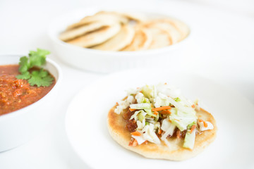 Pupusas from El Salvador with delicious salsa and curtido