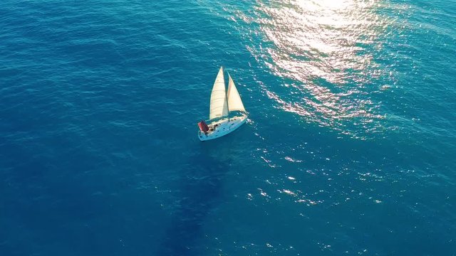 Aerial view. Yacht sailing on open sea at sunny day.