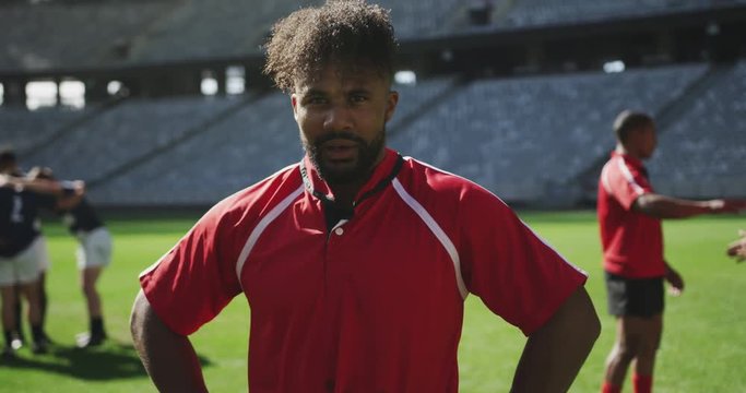 Male rugby player standing with hands on hip in stadium 4k
