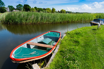small boats in canal. Broek op Langedijk, The Netherlands