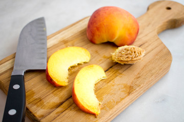 Slicing Peaches on a Wood Cutting Board