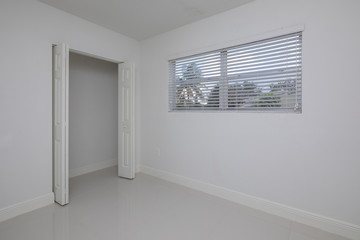 Empty room with a closet painted white
