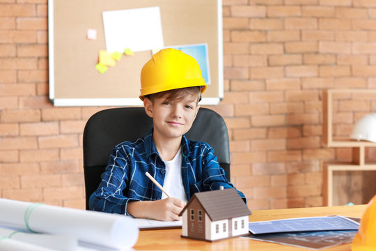 Cute little architect working in office