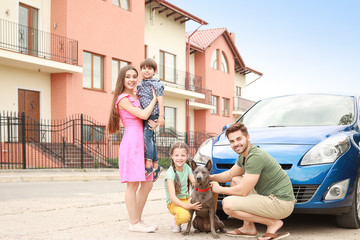 Fototapeta na wymiar Happy family with dog near car outdoors