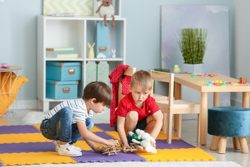 Cute little children playing in kindergarten