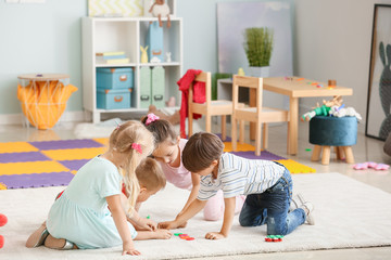 Cute little children playing in kindergarten