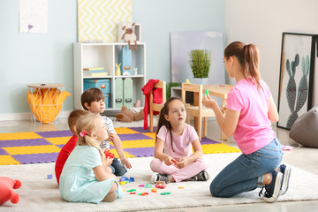 Cute little children learning letters in kindergarten