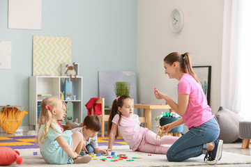 Cute little children learning letters in kindergarten