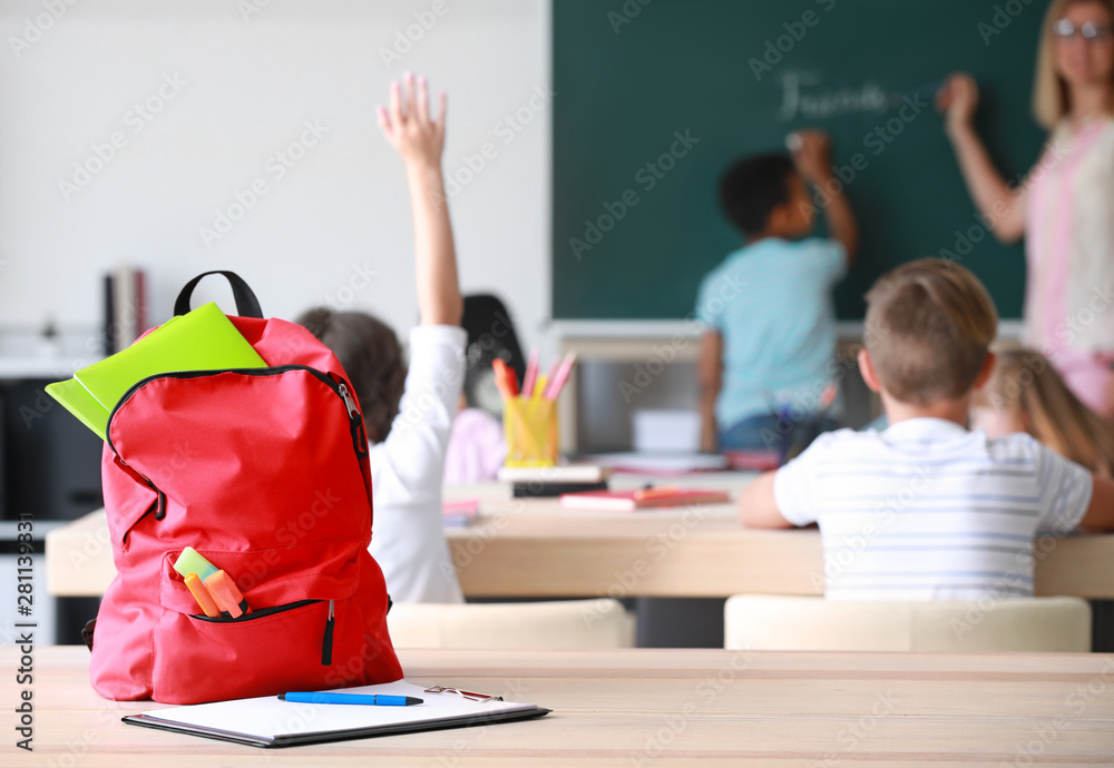 Canvas Prints School backpack with stationery on table in classroom