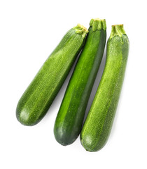 Fresh zucchini squashes on white background
