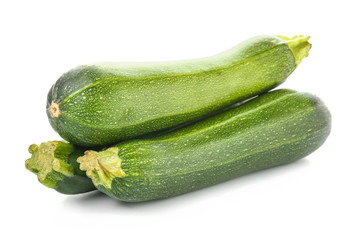 Fresh zucchini squashes on white background