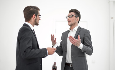 business colleagues discussing a working paper while standing in the office