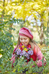 Girl with Down syndrome in autumn park.