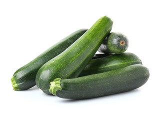 Fresh zucchini squashes on white background