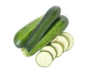 Fresh zucchini squashes with pieces on white background