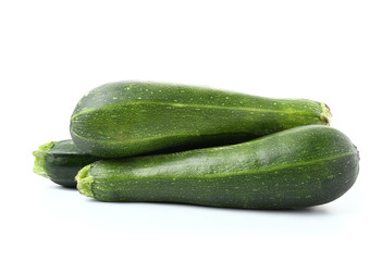 Fresh zucchini squashes on white background