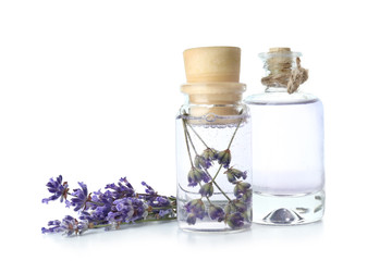 Bottles of lavender essential oil on white background