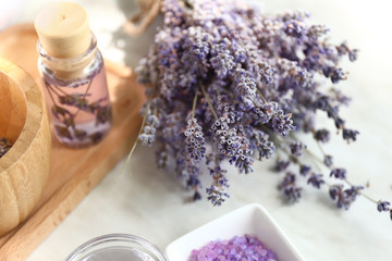 Fototapeta na wymiar Lavender flowers with cosmetics on light table