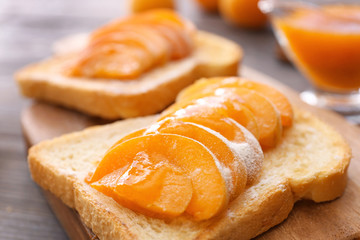 Bread slice with tasty apricots, closeup