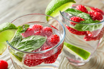 Glasses of raspberry lemonade on table, closeup