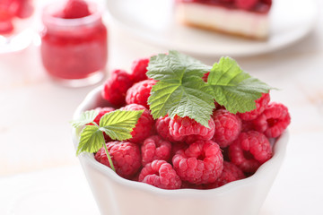 Bowl of fresh raspberries on table, closeup