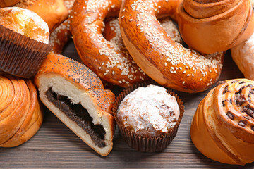 Heap of tasty pastries on wooden background