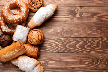 Heap of tasty pastries on wooden background
