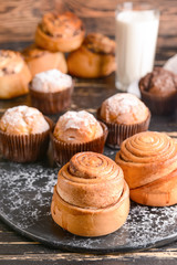 Tasty buns with muffins on board