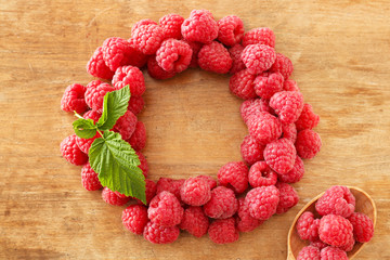 Fresh raspberries on wooden table