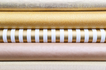 Golden glossy wrapping paper rolls
