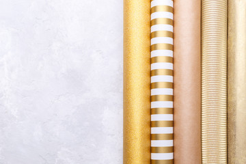 Golden glossy wrapping paper rolls