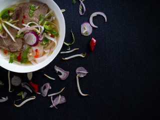 Spicy Vietnamese soup (pho bo) with fresh cilantro and soybeans