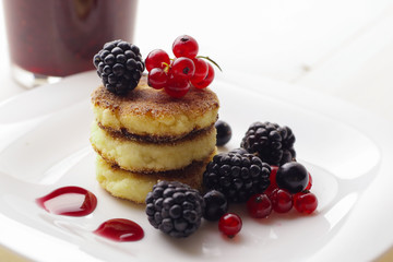 Cottage cheese pancakes or syrniki on plate, close up