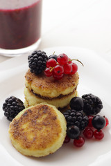 Cottage cheese pancakes or syrniki on plate, close up