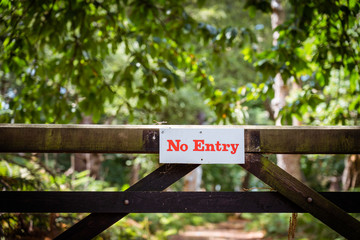 No entry board sign on a fence in the forest. Nature reserve territory. Protection of private property. Copy space.