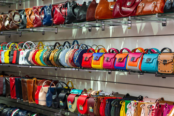 Different kind of leather purse bags colorful vibrant colors selling in the Italian market shop - obrazy, fototapety, plakaty