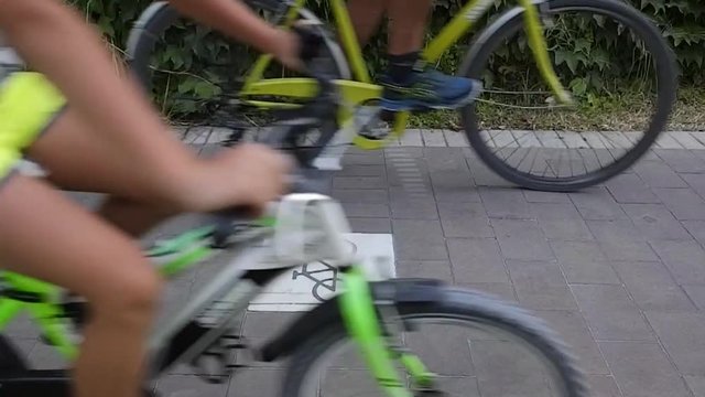 Bicycles run along a bike path, widely used in summer by tourists visiting the city. In slow motion 2