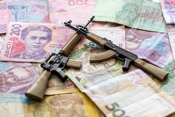 ukrainian hryvnia american m16 and soviet ak47 assault rifles armed conflict support concept