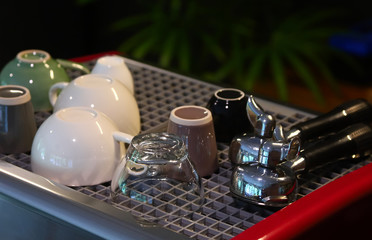 Coffee cups and the portafilters on the coffee machine