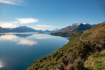 Beautiful Lake Wakatipu coastline under the slopes of the majestic Southern Alps