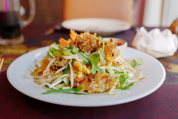 Oyster or Mussel crispy omelette serve on white plate with spicy red chilli sauce on side. Thai style Mussel omelette.