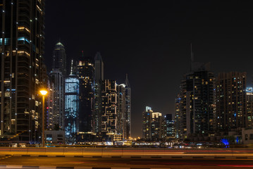 Fototapeta premium View of Dubai Marina by night in long exposure, UAE. May 2019