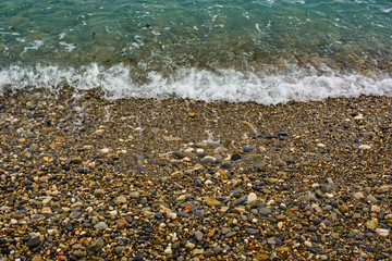 Pebble shore of French Riviera in Nice, natural background