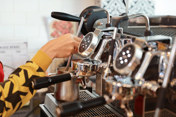 close up young muslim barista girl hands making coffee