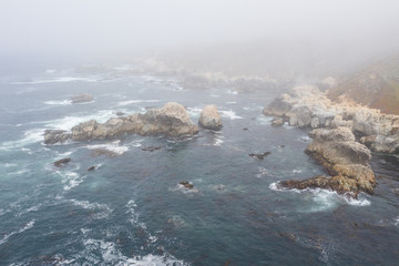 Seen from a bird's eye view, the Pacific Ocean washes against the rocky coast south of Monterey in Northern California. This beautiful area runs parallel to the famed Pacific Coast Highway.