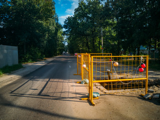 Fenced road repair area. Excavation for repairing sewer
