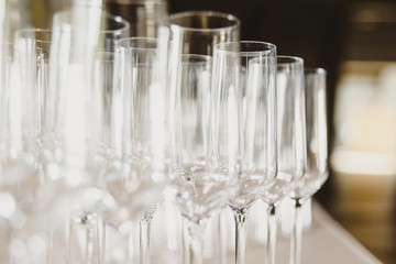 Group of empty and transparent champagne glasses in a restaurant.Group of empty and transparent champagne glasses in a restaurant.
