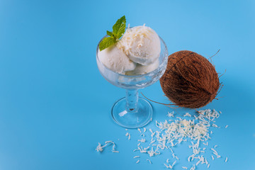 Coconut ice cream, three scoops in a glass bowl